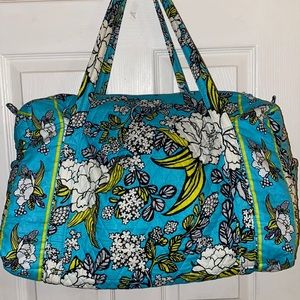 Overnight Bag. Fabric with floral design. Washable. Two side pockets.